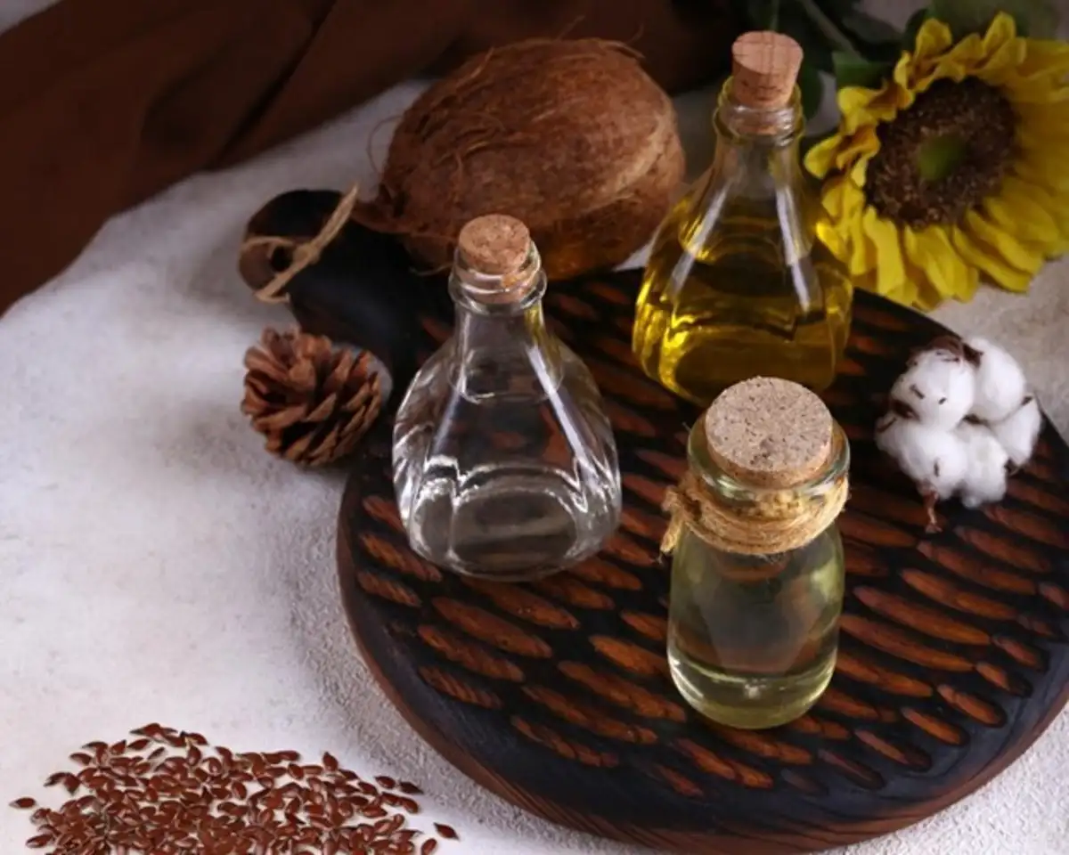 Bottle of Oil and Nuts on table