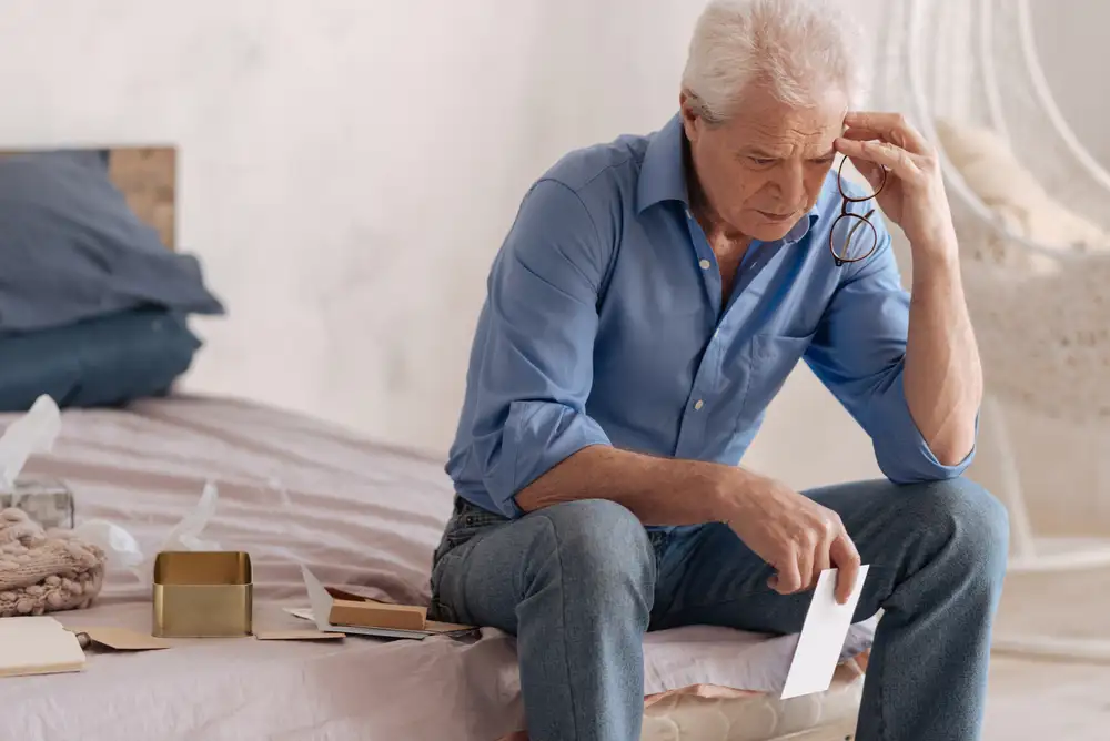 Worried Adult Man Sitting on a Bed