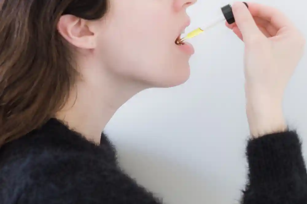 woman taking cannabis tincture