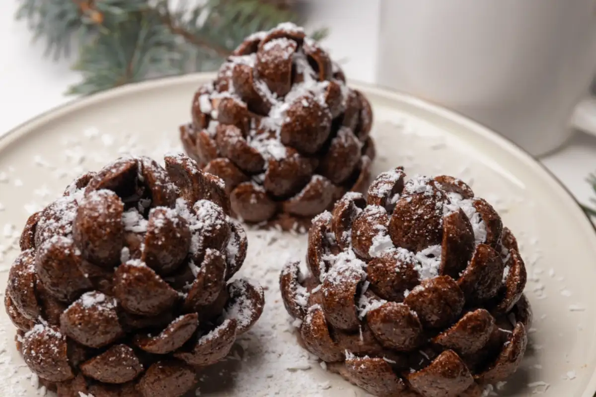 Christmas tree cone shaped cookies with chocolate flakes with powdered sugar