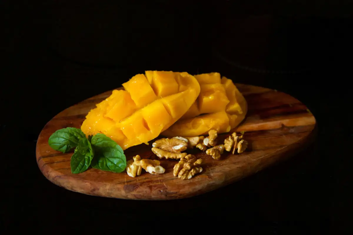 Sweet mango on wooden plate