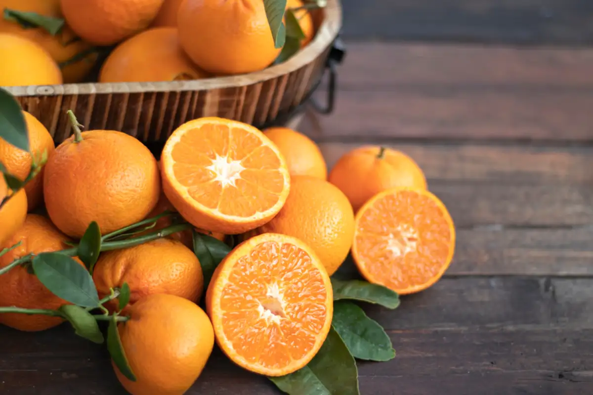 Orange fruit with green leaves on the table