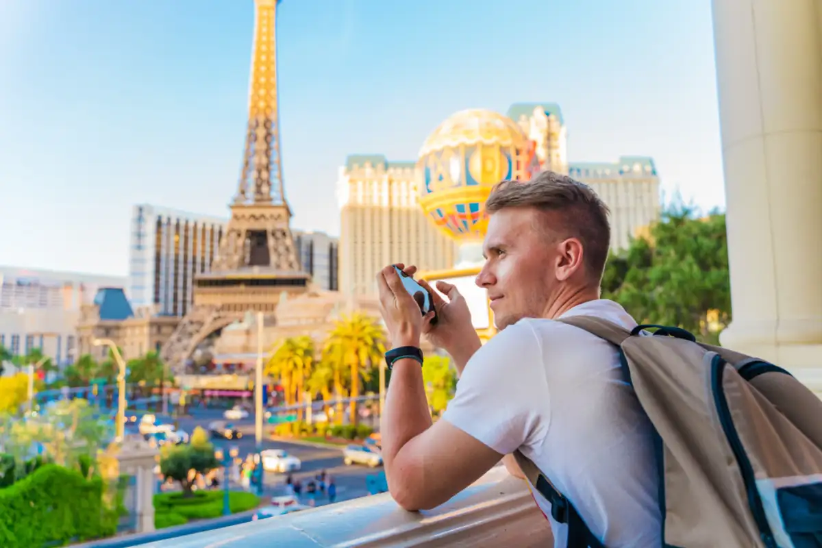 A young man photographs a panorama of the city