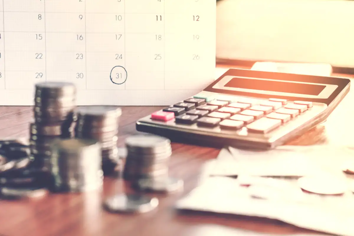 calculator and coin money on table