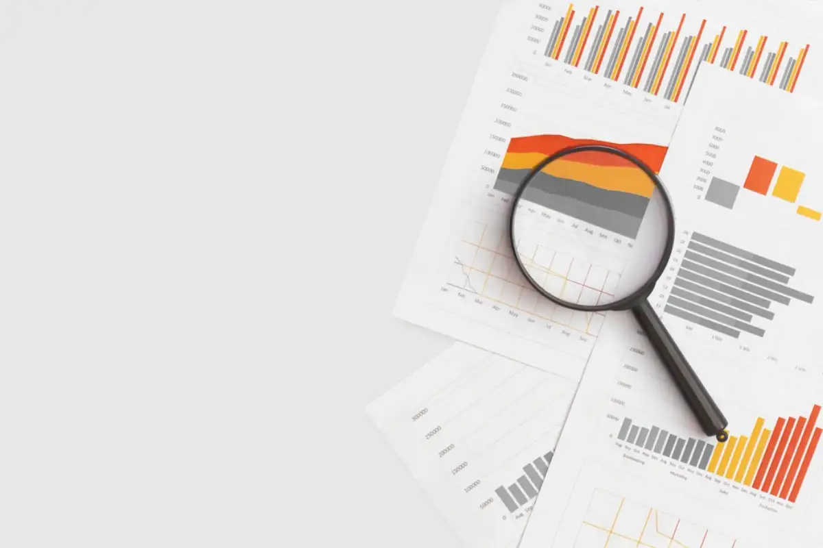 charts and magnifying glass on table